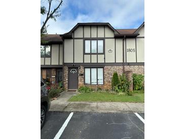 Inviting townhome with a well-maintained lawn and a charming brick facade at 1805 Ashborough Se Cir # D, Marietta, GA 30067