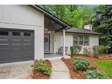 Charming single-story home features a welcoming entrance, manicured landscaping, and a convenient attached garage at 1965 Stilesboro Nw Dr, Kennesaw, GA 30152