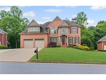 Beautiful brick two-story home featuring a well-manicured front lawn and a two-car garage at 3341 Cranmore Chase, Marietta, GA 30066