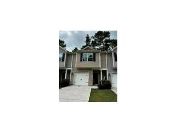 Charming townhome featuring a one-car garage, neutral siding, and a well-maintained front yard at 107 Highwood Ln, Atlanta, GA 30344