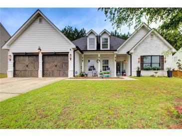 Charming two-story home features a well-manicured lawn and a welcoming front porch at 51 Norton Ave, Acworth, GA 30101