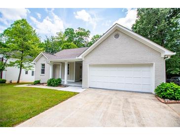 Charming single-story home featuring an attached garage, manicured lawn, and inviting curb appeal at 9691 Squirrel Wood Run, Douglasville, GA 30135