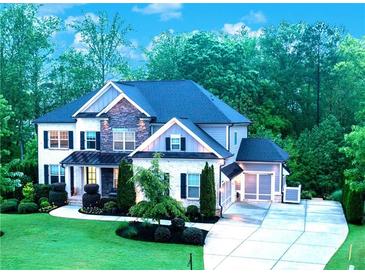 Beautiful two story home with stone accents and a well manicured front yard and driveway at 3755 Valleyway Rd, Cumming, GA 30040
