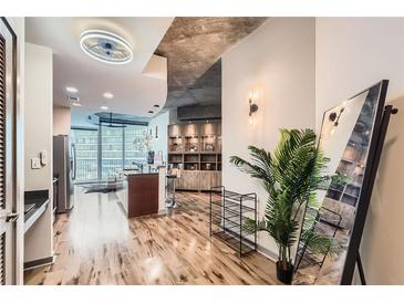 Open-concept living space features hardwood floors, modern lighting, and stylish decor in this inviting condo at 400 W Peachtree Nw St # 2614, Atlanta, GA 30308