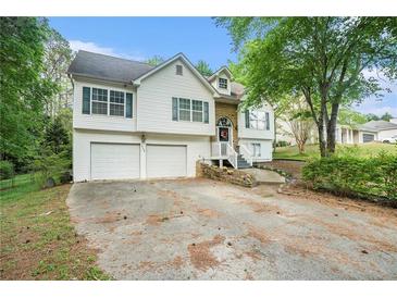 Charming two-story home with a two-car garage and a well-manicured front yard at 3140 Willow Park Dr, Dacula, GA 30019