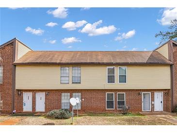 Charming townhome featuring brick and vinyl siding under a blue sky with fluffy clouds at 3162 Citrus Ct, Decatur, GA 30034