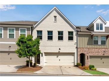 Charming townhome features a painted brick facade, attached garage, and well-maintained landscaping at 355 Niles Ct # 2, Marietta, GA 30060