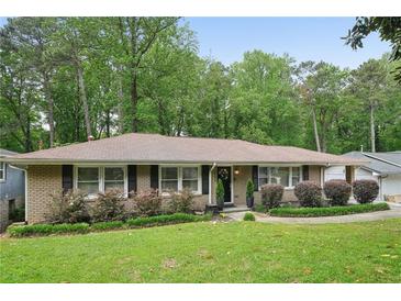 Charming brick home with lush green lawn and mature landscaping at 2193 Cloverdale Se Dr, Atlanta, GA 30316