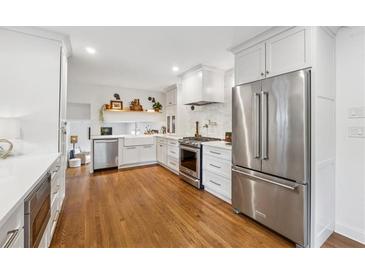 Bright kitchen features stainless steel appliances, hardwood floors, and white cabinetry at 3772 Evans Rd, Atlanta, GA 30340