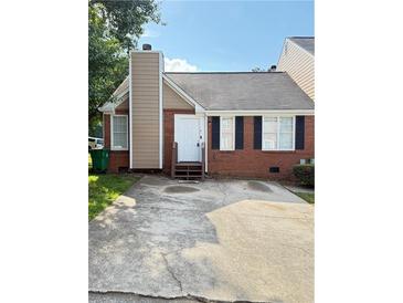 Charming brick home featuring a concrete driveway and inviting front entrance with a chimney at 2115 Charter Ln, Lithonia, GA 30058