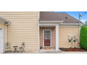 Inviting home featuring a front door with decorative ironwork and a charming seating area at 202 Accord Sw Ln, Grayson, GA 30017