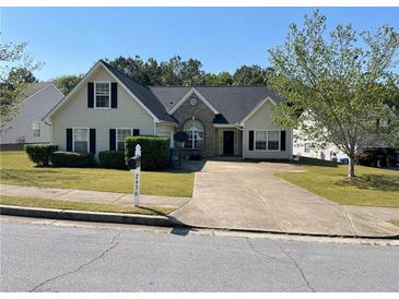 Charming single-Gathering home featuring a well-maintained front yard, a symmetrical design, and an inviting entrance at 2436 Moultrie Ct, Dacula, GA 30019