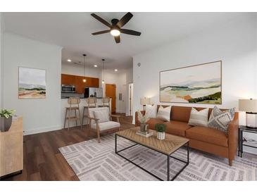 Bright living room featuring modern furnishings, hardwood floors and an open floor plan with a view into the kitchen at 384 Ralph Mcgill Ne Blvd # 318, Atlanta, GA 30312