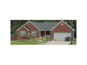 Charming brick home with a well-manicured front yard and attached garage, perfect for suburban living at 2582 Oak Bluff Dr, Dacula, GA 30019