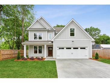 Charming two-story home with a well-manicured lawn and a two car garage at 1701 Aircraft S Dr, Marietta, GA 30060