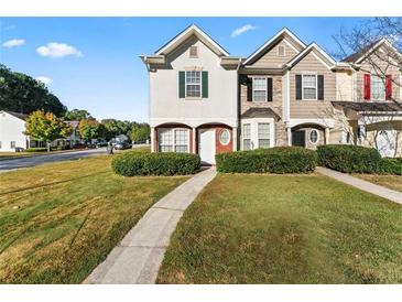 Charming townhome featuring a well-maintained lawn and inviting entryway at 6099 Camden Forrest Cv, Riverdale, GA 30296