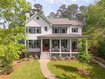 Charming two-story home with white siding, dark shutters, inviting front porch, and manicured landscaping at 132 Mount Vernon Dr, Decatur, GA 30030