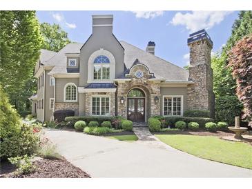 Stunning two-story home with stone accents, lush landscaping, and a circular driveway at 5118 Greythorne Ln, Marietta, GA 30068