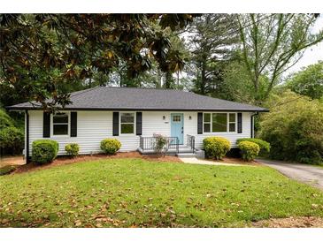 Charming home featuring a well-manicured lawn and a welcoming light blue front door at 2834 Vicksburg Ct, Decatur, GA 30034