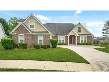 Beautiful single-story brick home with manicured lawn, charming curb appeal and driveway at 380 Vista Creek Dr, Stockbridge, GA 30281