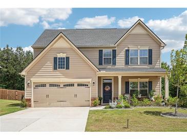 Charming two-story home boasts a well-manicured lawn, neutral siding, and a two-car garage at 537 Daffodil Ln, Mcdonough, GA 30253