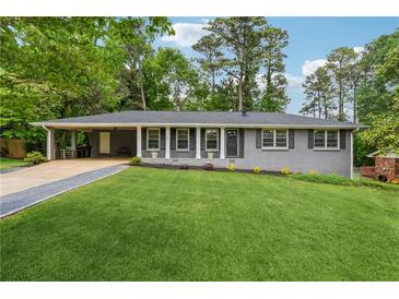 Charming single-story home with a well-manicured lawn and convenient carport at 1154 Pair Sw Rd, Marietta, GA 30060