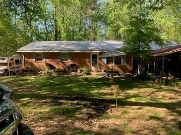 Charming brick home with mature trees and landscaping at 3683 Miller St, Lithia Springs, GA 30122