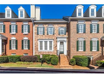 Charming brick townhome with manicured landscaping and classic architectural details at 4656 Ivygate Se Cir, Atlanta, GA 30339