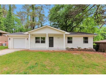Charming one-story home with a well-maintained front yard and painted white brick at 1660 Mallard Cir, Conley, GA 30288