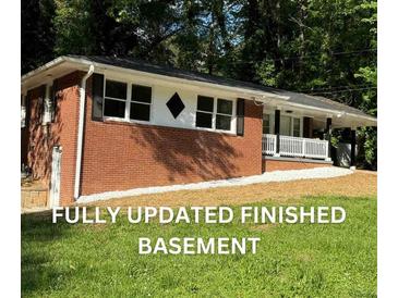 Charming brick home with a freshly landscaped yard and inviting front porch at 257 E Simon Nw Ter, Atlanta, GA 30318