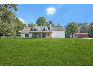 Charming home with stone accents, large front yard, and outbuilding at 3880 Dial Mill Ne Rd, Conyers, GA 30013