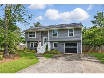 Charming two-story home with gray siding, white trim, landscaped yard, and attached one-car garage at 1501 Jamerson Landing, Marietta, GA 30066
