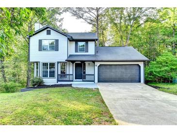 Charming two-story home with a well-manicured lawn and an attached two-car garage at 2211 Rocky Mill Dr, Lawrenceville, GA 30044