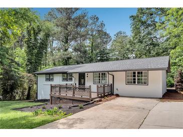 Charming renovated home with a deck, landscaped front yard, and a modern white exterior at 30 Dewey Se Ln, Marietta, GA 30060