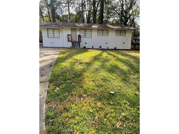 Charming single-story home with a well-maintained front yard and updated exterior at 735 Brookwood Dr, Forest Park, GA 30297