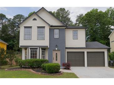 Charming two-story home featuring a two-car garage and manicured front yard at 1075 Litchfield Sw Way, Marietta, GA 30060