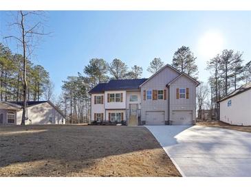 Charming two-story home with a symmetrical design, featuring a long concrete driveway and manicured lawn at 3279 Greenhill Dr, Villa Rica, GA 30180