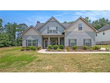 Charming two-story home with light blue siding, gray shutters, and well-manicured landscaping at 101 Ruby Lane, Mcdonough, GA 30252