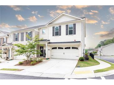 Charming two-story townhouse with a two-car garage, beautiful landscaping and a welcoming entrance at 500 Garvin Dr, Woodstock, GA 30189