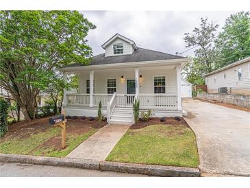 Charming two-story home with a inviting front porch and well-manicured lawn and garden at 1555 New Ne St, Atlanta, GA 30307