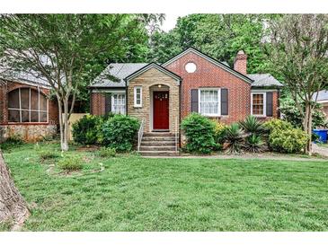 Charming brick home with a red door, stone accents, and a well-manicured front lawn at 1798 Melrose Sw Dr, Atlanta, GA 30310