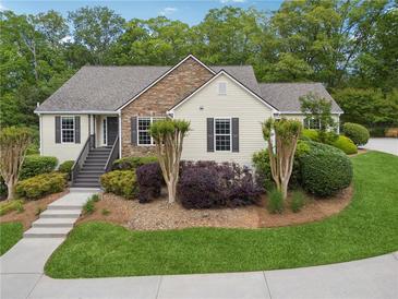 Charming home featuring manicured landscaping, stone accents, and a welcoming front porch at 4740 Union Hill Rd, Canton, GA 30115