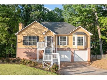 Inviting two-story home featuring a brick foundation, white stairs, and a charming facade at 2114 Lindley Nw Ln, Kennesaw, GA 30144