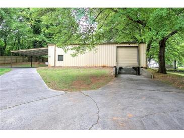 Commercial building with a loading dock, carport, and green space offers versatile functionality at 200 Rogers Rd, Kingston, GA 30145