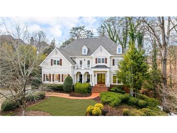 Beautiful two-story home featuring manicured landscaping, a brick walkway, and an inviting front entrance at 2616 Boddie Pl, Duluth, GA 30097
