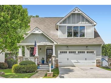 Charming two-story home boasts inviting curb appeal and a well-maintained front yard and attached garage at 2686 Oak Leaf Se Pl, Atlanta, GA 30316