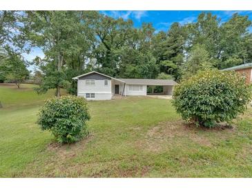 Charming single-story home with a well-maintained front yard and convenient carport at 1520 Oxford St, Douglasville, GA 30134