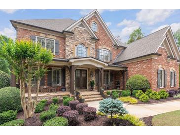 Stunning two-story brick home with stone accents and a beautifully landscaped front yard at 5475 Copper Creek Pass, Cumming, GA 30040