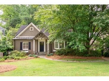 Charming home exterior featuring a well-manicured lawn, mature trees, and inviting curb appeal at 3115 Peachtree Ne Dr, Atlanta, GA 30305