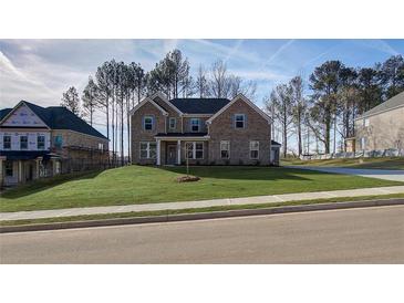 Beautiful two-story brick home with a well-manicured lawn and a classic architectural design at 322 Delta Dr, Mcdonough, GA 30253